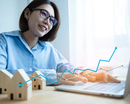 Woman analyzing real estate market on her laptop.
